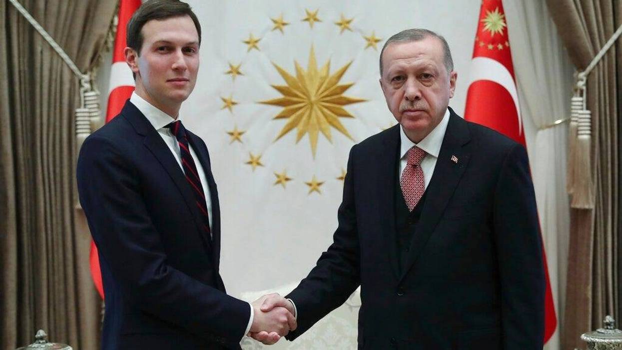 Turkey's President Recep Tayyip Erdogan, right, shakes hands with Jared Kushner, left