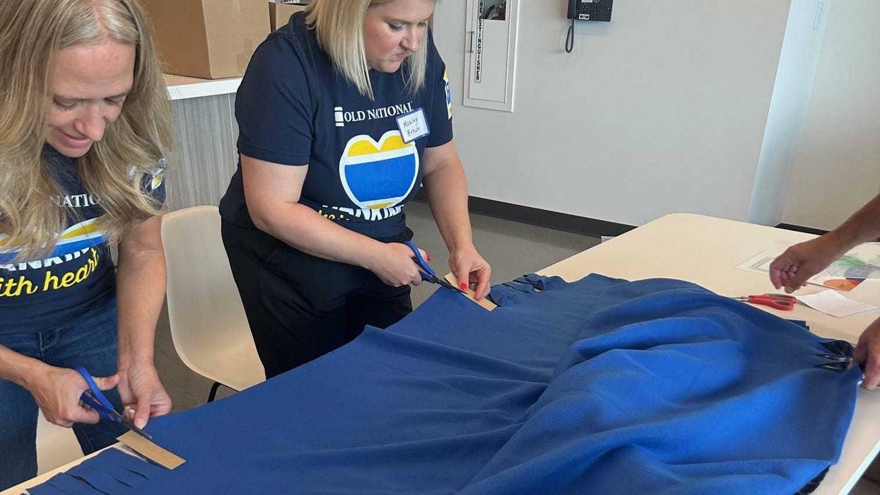 Twin Cities volunteers pack 100 boxes of supplies for families transitioning out of homelessness.