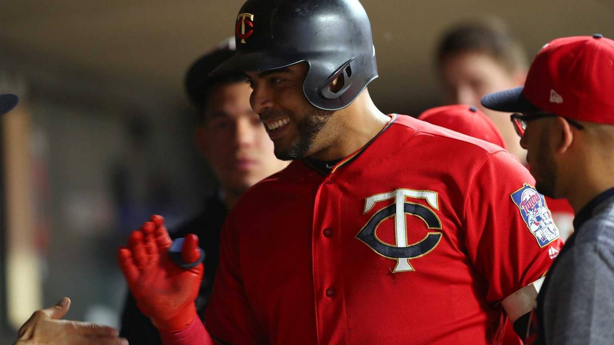 Twins DH Nelson Cruz celebrates in dugout