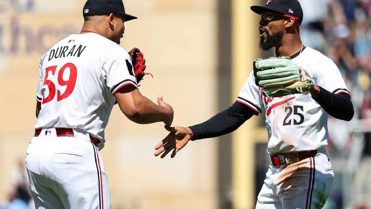 Twins pitcher Jhoan Duran (59) and center fielder Byron Buxton (25) celebrate their teams win against the Baltimore Orioles after the game at Target Field.
