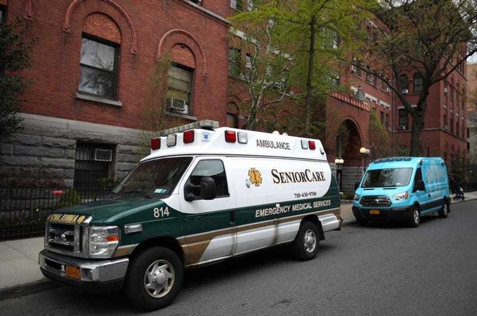Two ambulances sit parked outside the Cobble Hill Health Center on April 18, 2020 in the Cobble Hill neighborhood of the Brooklyn borough of New York City