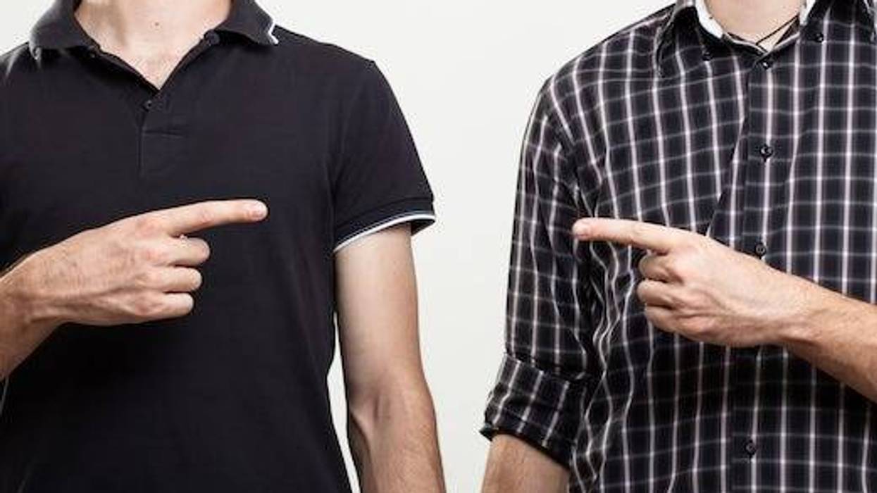 Two men pointing at each other