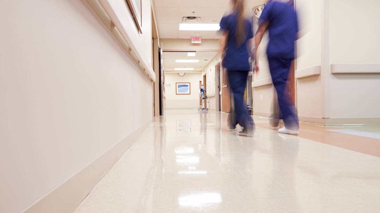 Two nurses walking down hospital corridor
