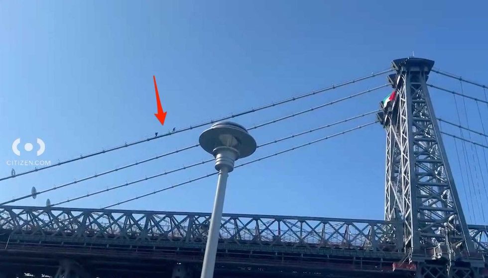 Two people, believed to be members of the NYPD, were seen heading up to the flag during the morning rush