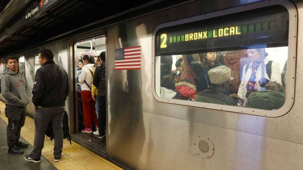 Two people wait on a platform to board a 2 train at the Times Sqaure subway station on Nov. 6, 2023.