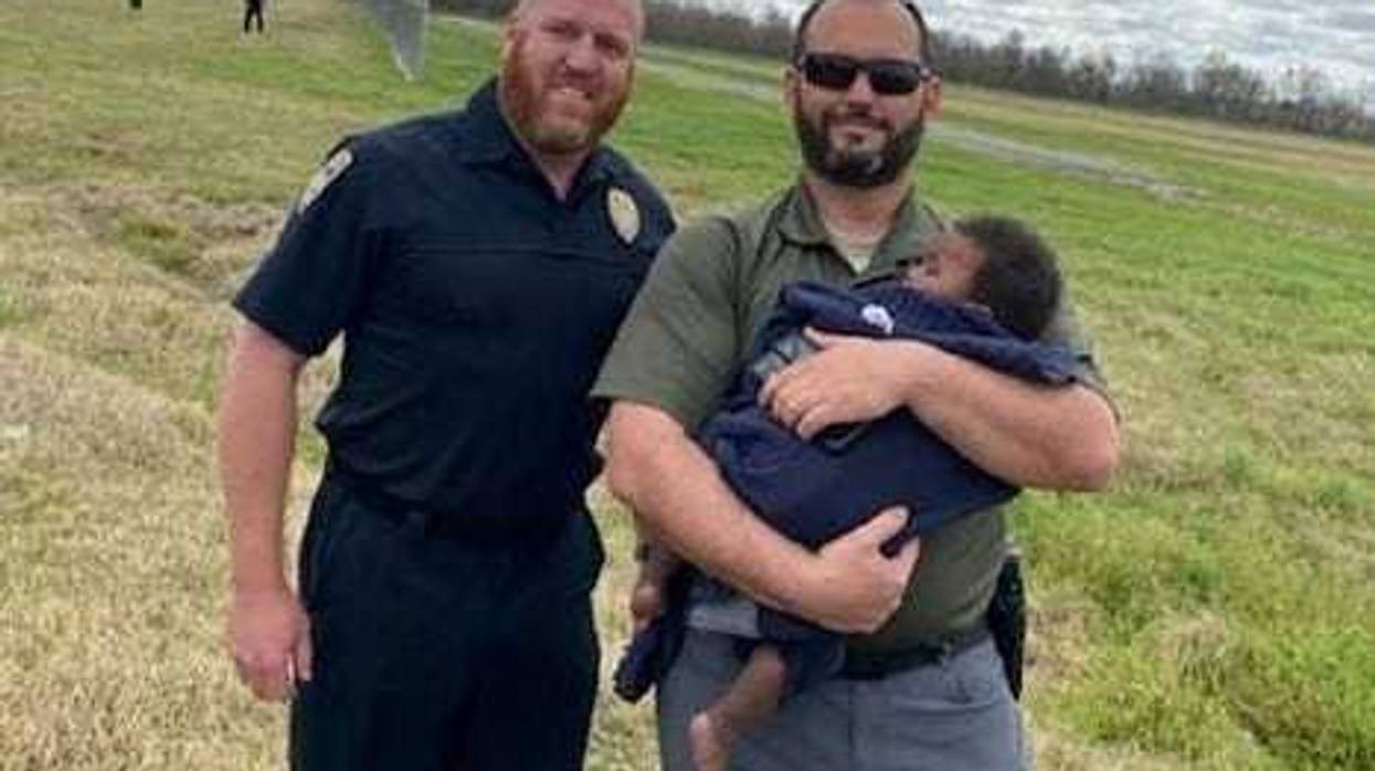 Two police with recovered baby