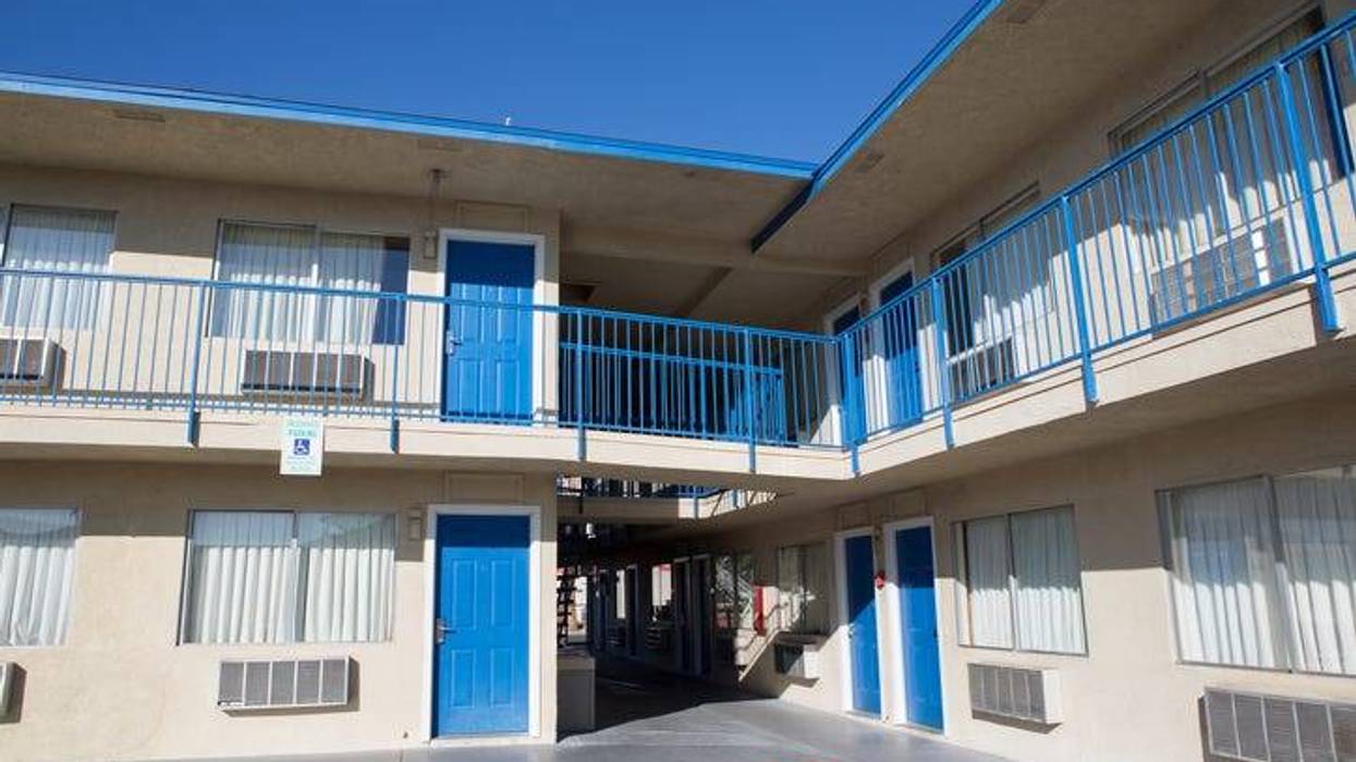 Two story motel with parking lot