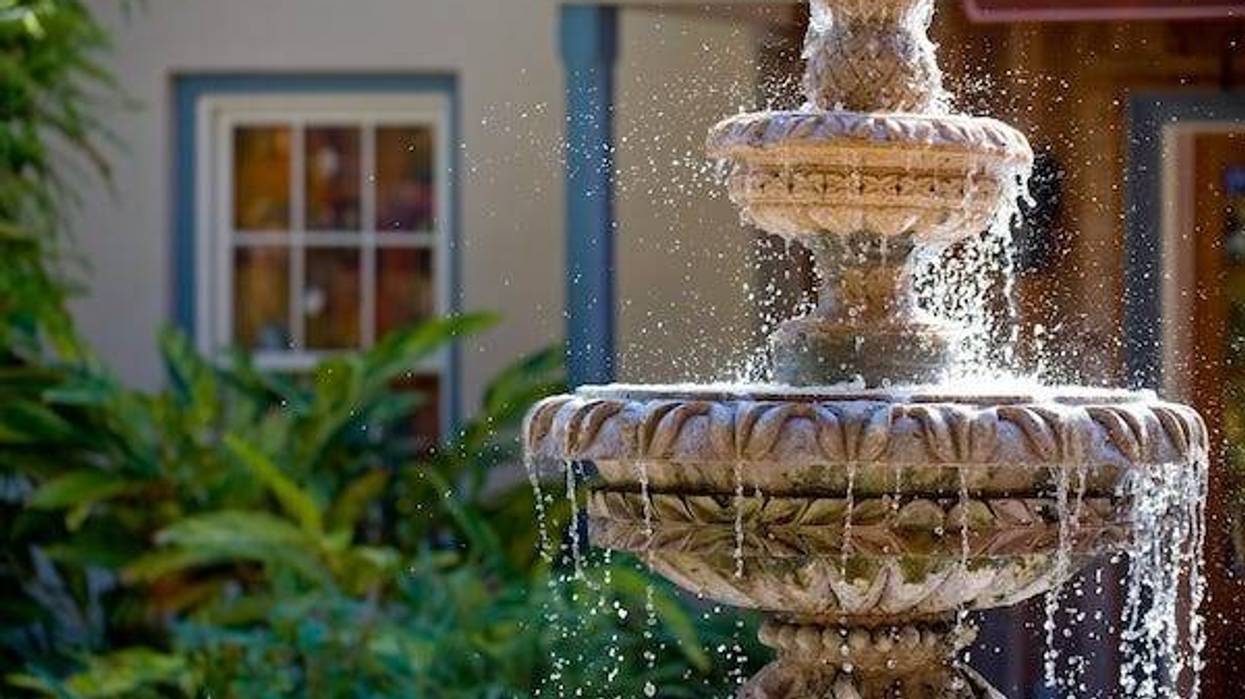 Two-tiered garden fountain flowing with water