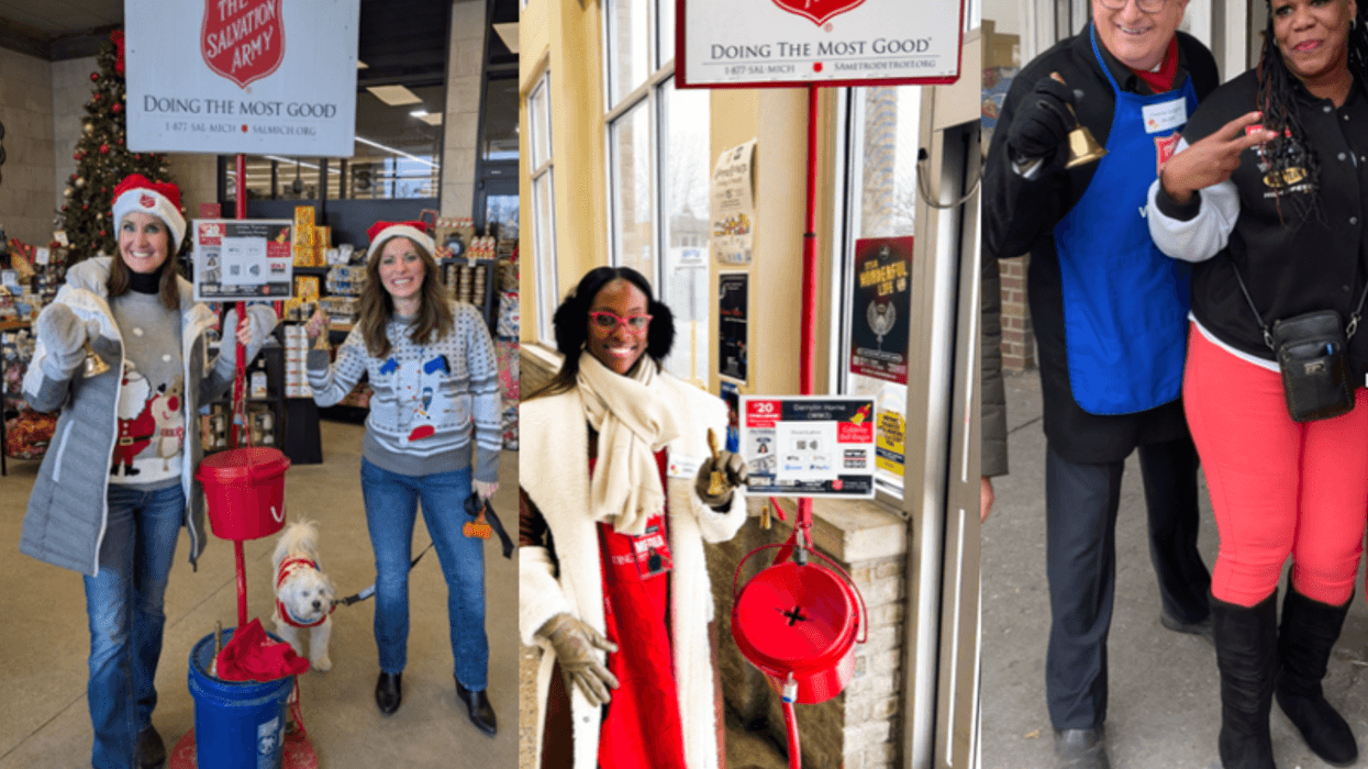 Two women ringing bells, one has dog