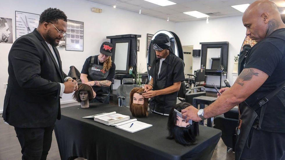 Tyce Combs is shown with Genevieve Blankley, Sharif Bland and Corey Blackwell at Generations Barber Academy.