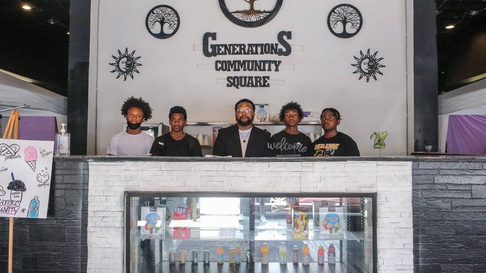 Tyce Combs stands with young men at Generations Community Square