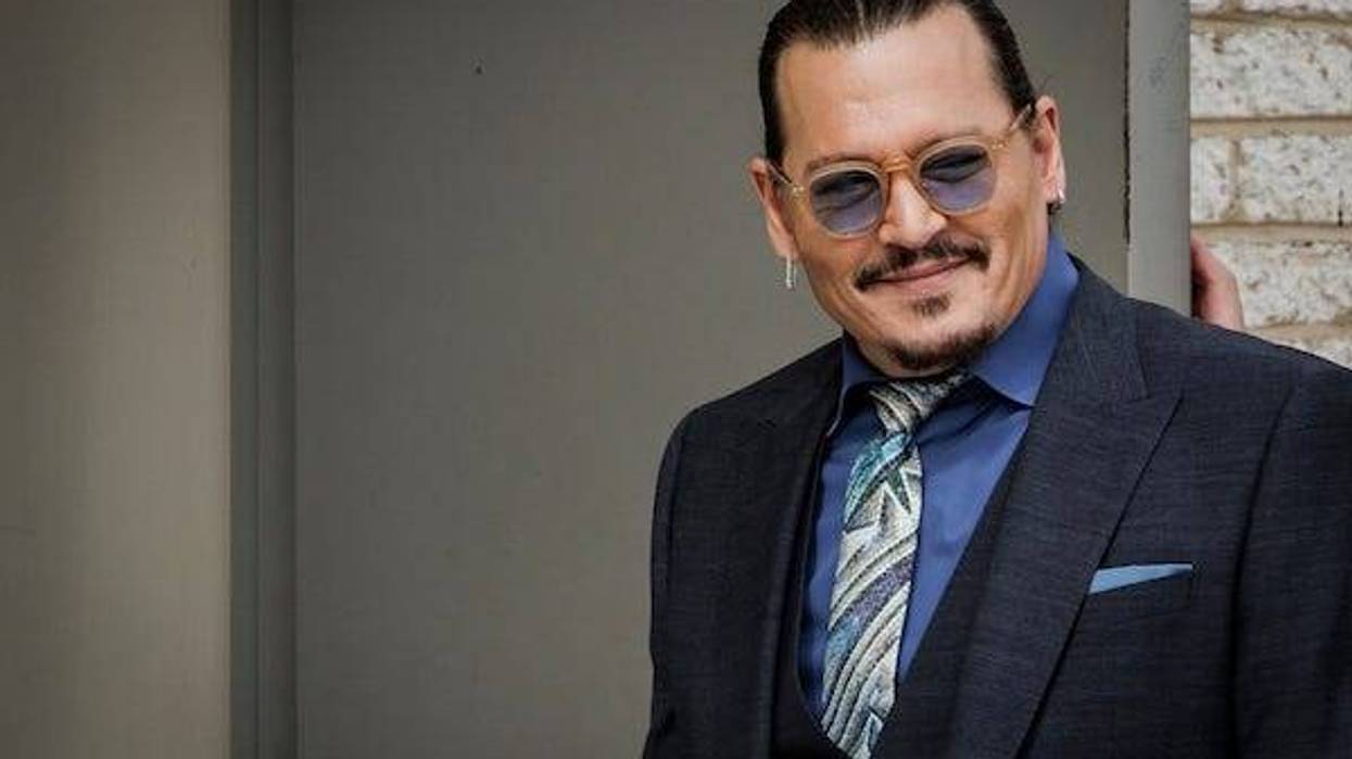 U.S. actor Johnny Depp smiles at fans as he walks back into the Fairfax Circuit Court during a break in the trial on May 25, 2022, 2021 in Fairfax, Va