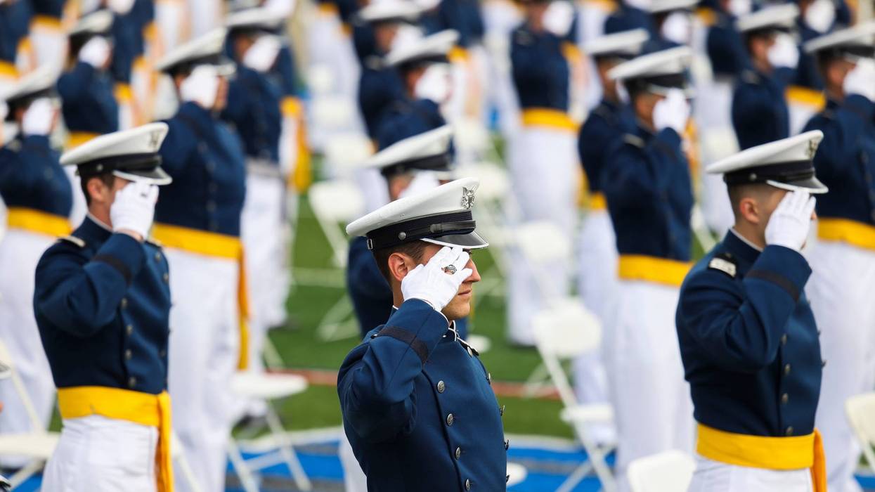 U.S. Air Force Academy graduates salute during a ceremony.