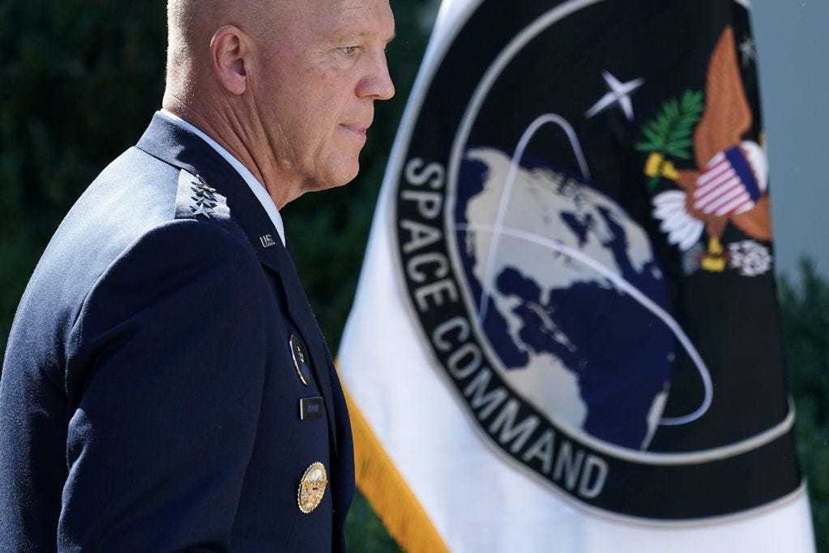 U.S. Air Force Space Command Gen. John "Jay" Raymond stands next to the flag of the newly established U.S. Space Command, the sixth national armed service, in the Rose Garden at the White House August 29, 2019 in Washington, DC.