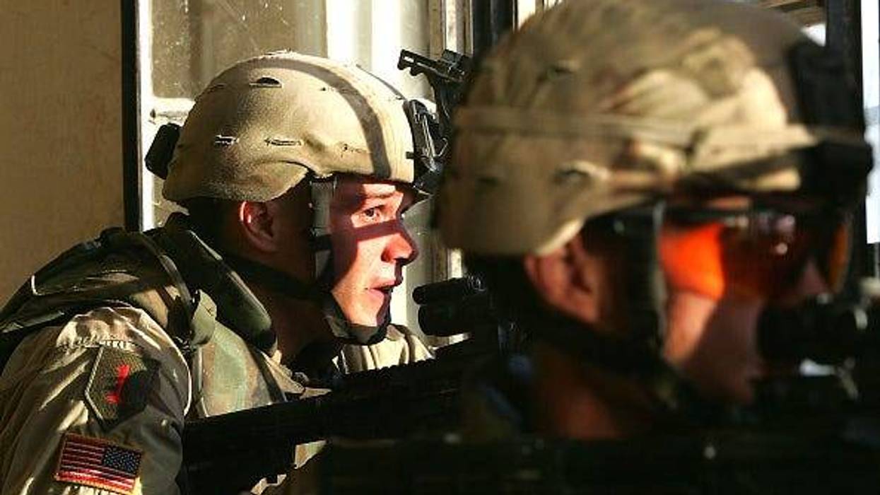 U.S. Army soldiers from the 1st Infantry Division's 2nd Battalion-2nd Regiment engage enemy forces in heavy fighting November 9, 2004 in the insurgent stronghold of Fallujah, Iraq