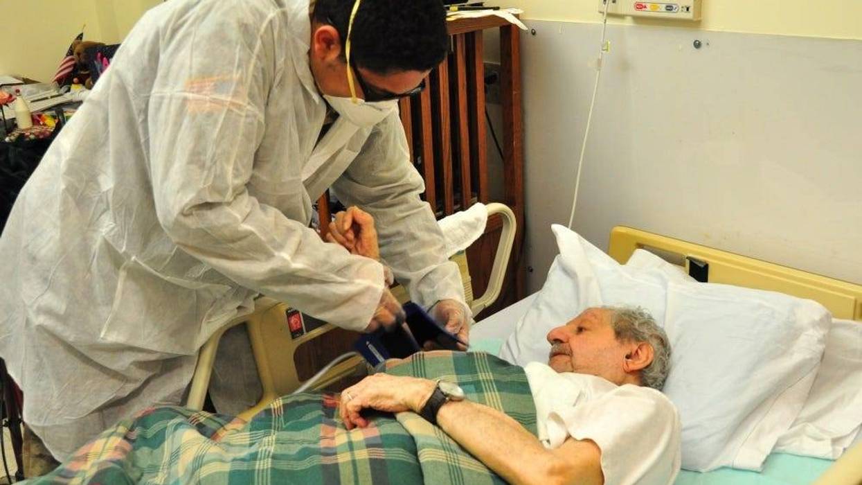 U.S. Army Spc. Jabari Ashanti, a Combat Medic with the 1st Battalion, 114th Infantry Regiment, New Jersey Army National Guard (NJARNG), checks a resident’s blood pressure at the New Jersey Veterans Memorial Home at Menlo Park in Edison, N.J., April 17, 20