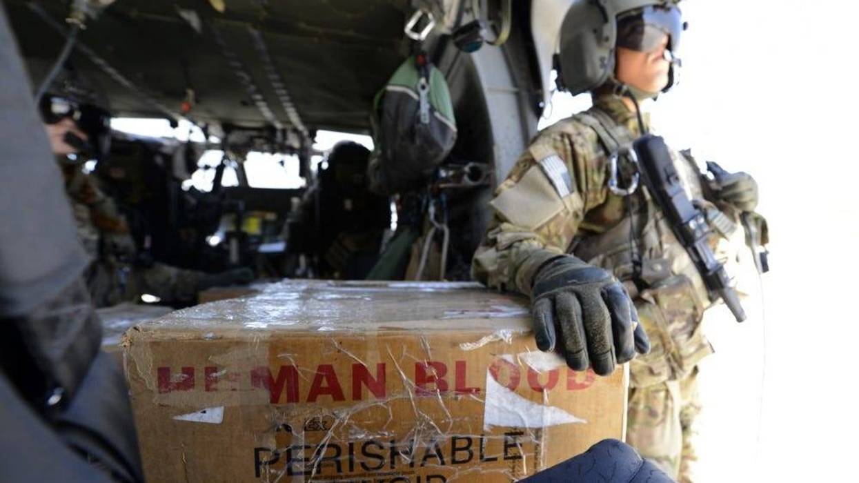 U.S. Army Spc. Robert Moher, 159th Combat Aviation Brigade crew chief, stands by to deliver blood in Afghanistan, July 2014. Moher, a Harlem, N.Y. native, is deployed from Fort Campbell, Ky. Joint Theater Trauma System members ensure fresh blood is always on hand.