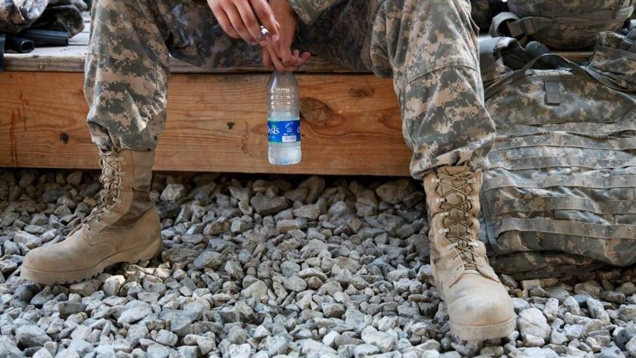 U.S. Army Spc. William Lang, 25, from Dallas, Texas, assigned to the Kapisa-Parwan Provincial Reconstruction Team, smokes a cigarette while waiting to go out on mission from Bagram Airfield, Afghanistan on Aug. 9.