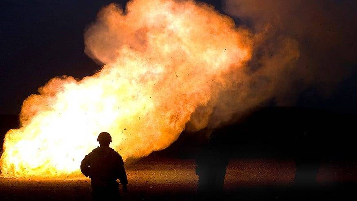 U.S. Army Staff Sgt. Alexis Castillo watches as unused mortar ‘cheese’ charges are disposed by fire during a mortar training exercise with Iraqi soldiers.