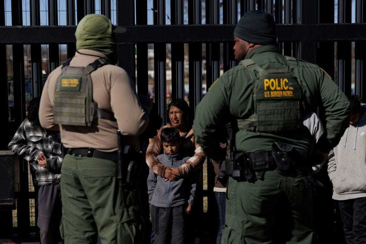 U.S. Border Patrol agents guard migrants that crossed into Shelby Park as they wait to be picked up for processing on February 4, 2024 in Eagle Pass, Texas.