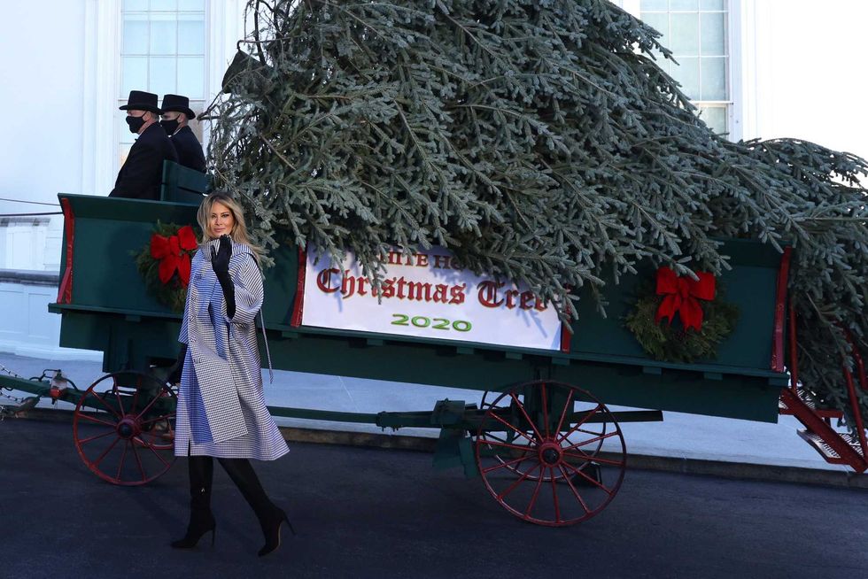 U.S. first lady Melania Trump waves as she receives the 2020 White House Christmas Tree November 23, 2020 at the White House in Washington, DC. The 18 foot tall Fraser Fir from West Virginia will be decorated and displayed in the Blue Room of the White House for this holiday season.