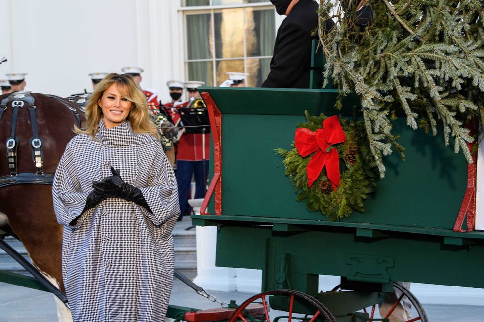 U.S. first lady Melania Trump waves as she receives the 2020 White House Christmas Tree November 23, 2020 at the White House in Washington, DC. The 18 foot tall Fraser Fir from West Virginia will be decorated and displayed in the Blue Room of the White House for this holiday season.