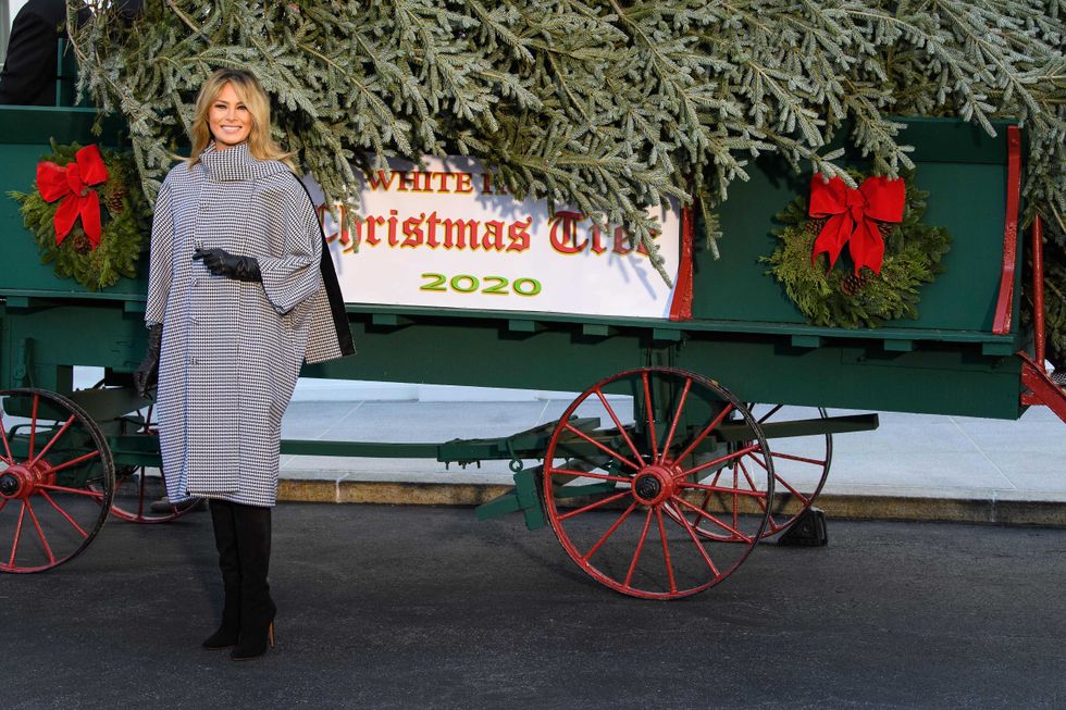U.S. first lady Melania Trump waves as she receives the 2020 White House Christmas Tree November 23, 2020 at the White House in Washington, DC. The 18 foot tall Fraser Fir from West Virginia will be decorated and displayed in the Blue Room of the White House for this holiday season.