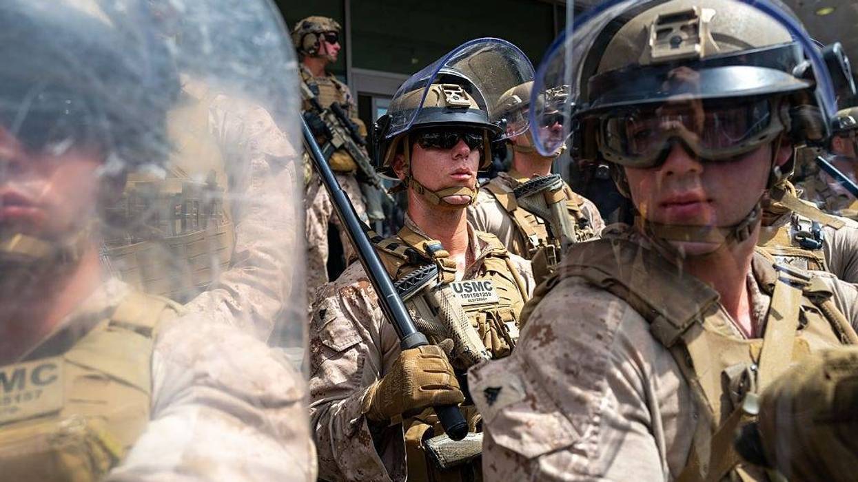 U.S. Marines are confronted by protesters outside a federal building in during an anti-Trump "No Kings Day" demonstration in a city that has been the focus of protests against Trump's immigration raids on June 14, 2025 in Los Angeles, California