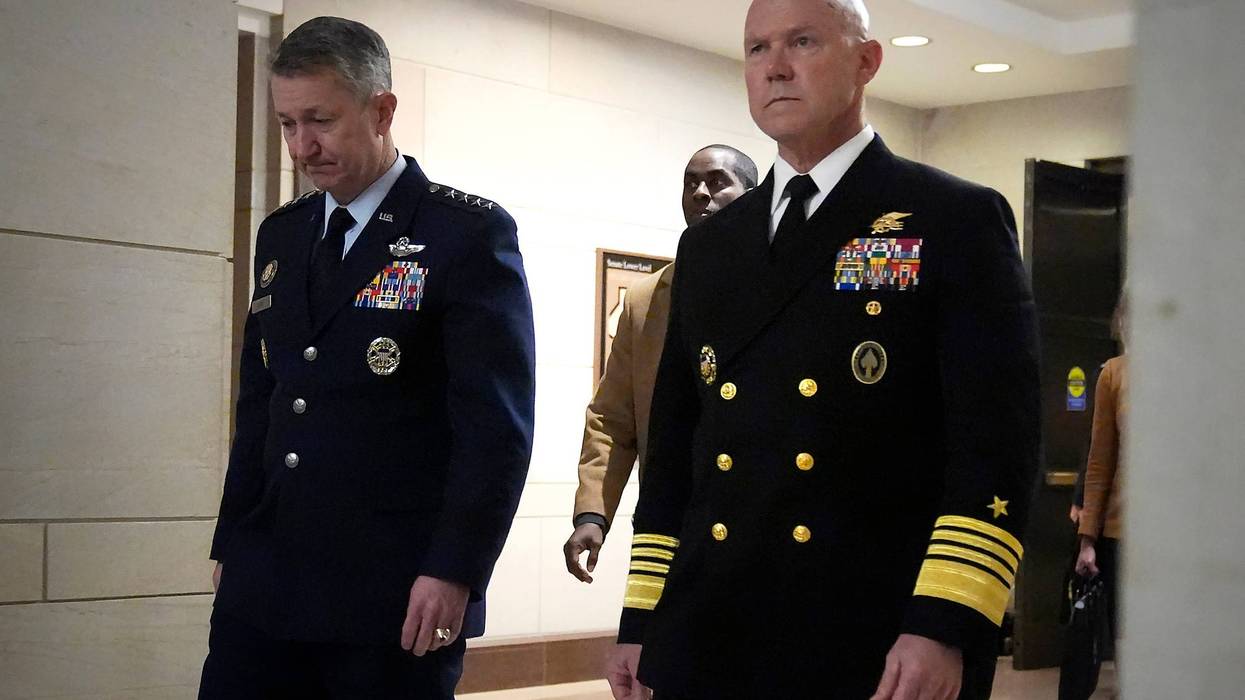 U.S. Navy Adm. Frank M. Bradley, right, accompanied by Gen. Dan Caine, chairman of the Joint Chiefs of Staff, left, walks to a meeting with senators on Capitol Hill, Thursday, Dec. 4, 2025, in Washington.