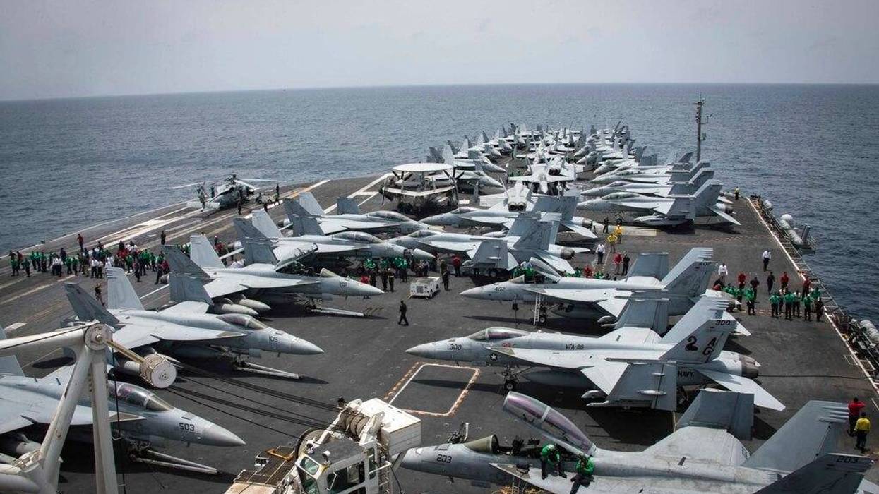 U.S. Navy, sailors partake in a foreign object and debris walk-down on the flight deck of the Nimitz-class aircraft carrier USS Abraham Lincoln in the Arabian Sea.