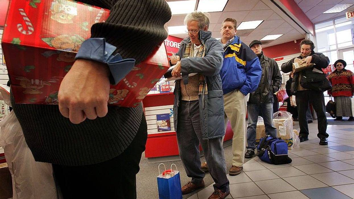 U.S. Postal Service customers wait in line to mail Christmas presents at a U.S. Post Office December 20, 2004 in Washington, DC.