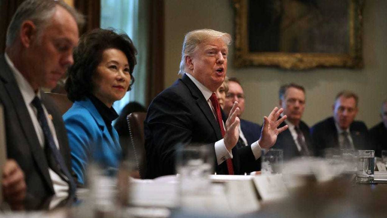 U.S. President Donald Trump (C) talks to reporters during a cabinet meeting with (L-R) Interior Secretary Ryan Zinke, Transportation Secretary Elaine Chao and others in the Cabinet Room at the White House October 17, 2018 in Washington, DC.