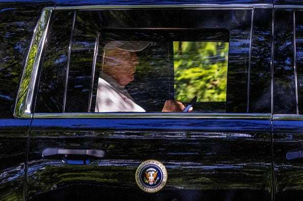 U.S. President Donald Trump checks his phone on August 31, 2025 in Washington, DC. President Trump spent the day at Trump National Golf Club during the labor day weekend. (Photo by Tasos Katopodis/Getty Images)