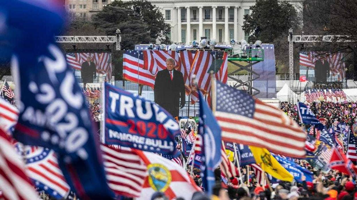 U.S. President Donald Trump is seen on a screen as his supporters cheer during a rally on the National Mall on January 6, 2021 in Washington, DC. Trump supporters gathered in the nation's capital today to protest the ratification of President-elect Joe Biden's Electoral College victory over President Trump in the 2020 election. (Photo by Samuel Corum/Photo by Samuel Corum/Getty Images)