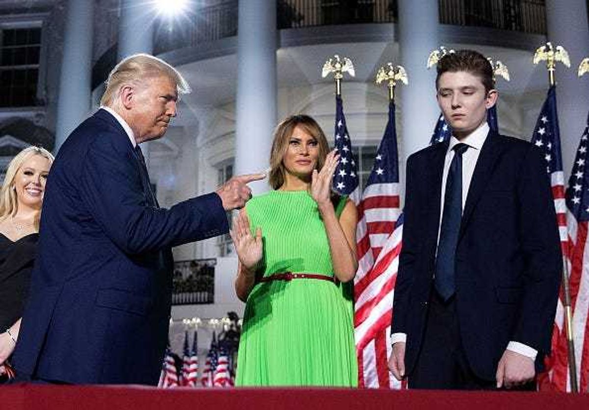 U.S. President Donald Trump (L) gestures toward first lady Melania Trump and his son Barron Trump after delivering his acceptance speech for the Republican presidential nomination on the South Lawn of the White House August 27, 2020 in Washington, DC.