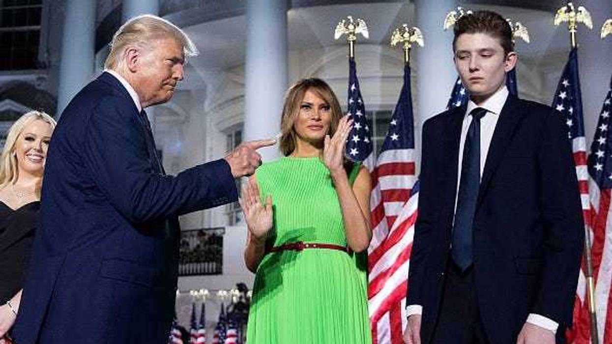 U.S. President Donald Trump (L) gestures toward first lady Melania Trump and his son Barron Trump after delivering his acceptance speech for the Republican presidential nomination on the South Lawn of the White House August 27, 2020 in Washington, DC.