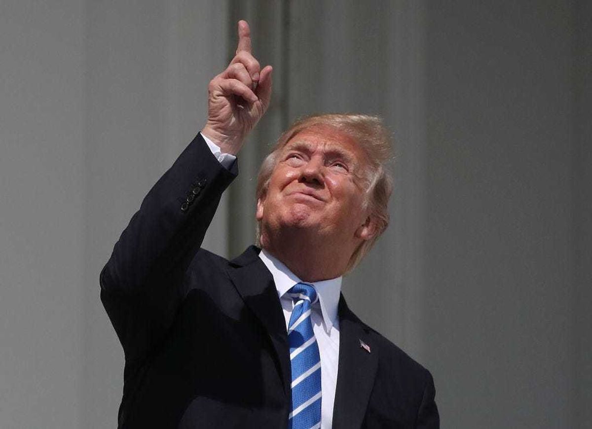 U.S. President Donald Trump looks up toward the Solar Eclipse on the Truman Balcony at the White House on August 21, 2017 in Washington, DC. Millions of people have flocked to areas of the U.S. that are in the "path of totality" in order to experience a total solar eclipse.