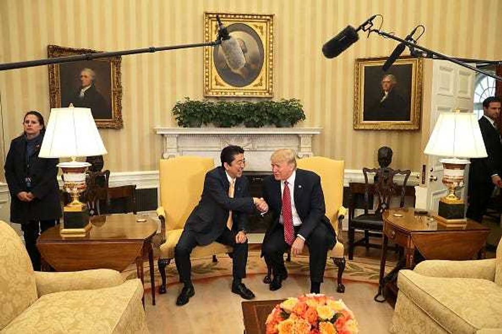 U.S. President Donald Trump (R) and Japanese Prime Minister Shinzo Abe pose for photographs before bilateral meetings in the Oval Office at the White House February 10, 2017 in Washington, DC. Trump and Abe are expected to discuss many issues, including trade and security ties and will hold a joint press confrence later in the day. (Photo by Chip Somodevilla/Getty Images)