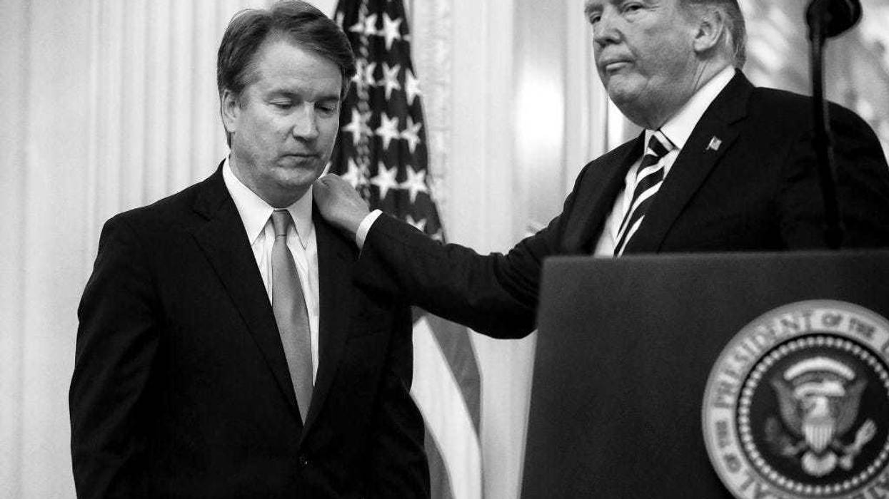 U.S. President Donald Trump (R) puts his hand on Supreme Court Associate Justice Brett Kavanaugh's shoulder during his ceremonial swearing in in the East Room of the White House October 08, 2018 in Washington, DC. Kavanaugh was confirmed in the Senate 50-48 after a contentious process that included several women accusing Kavanaugh of sexual assault. Kavanaugh has denied the allegations. (Photo by Chip Somodevilla/Getty Images)