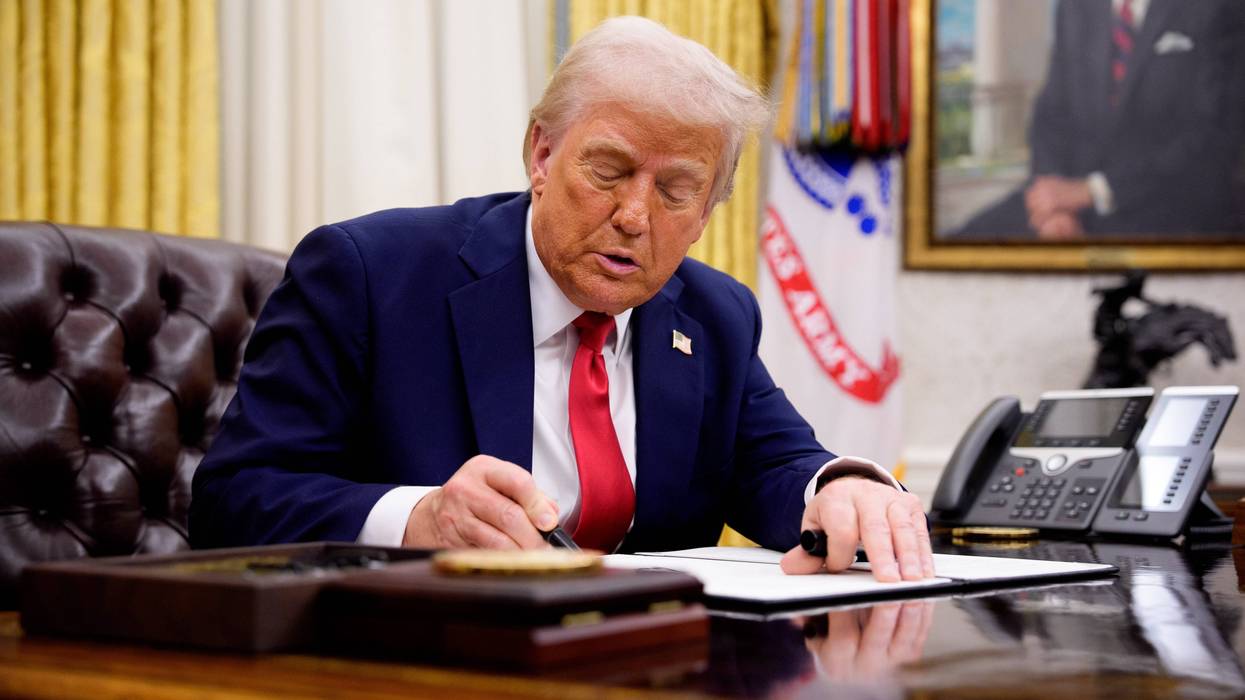 U.S. President Donald Trump signs an executive order in the Oval Office of the White House on March 31, 2025, in Washington, D.C.