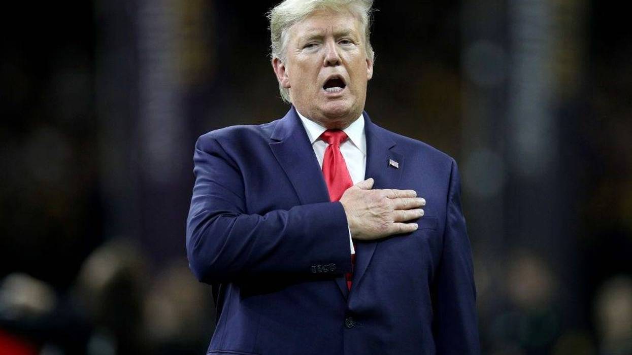 U.S. President Donald Trump stands for the national anthem prior to the College Football Playoff National Championship game between the Clemson Tigers and the LSU Tigers at Mercedes Benz Superdome on January 13, 2020 in New Orleans, Louisiana. (