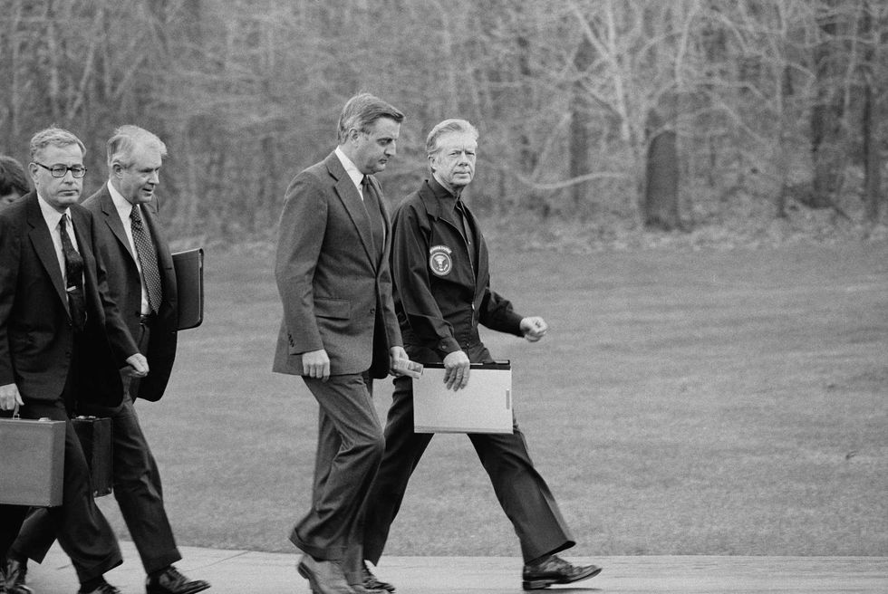 U.S. President Jimmy Carter, Vice President Walter Mondale, Secretary of State Cyrus Vance, and Secretary of Defense Harold Brown after disembarking from their helicopter to meet about Iran Hostage Crisis, Camp David, Maryland, USA, photograph by Marion S. Trikosko, November 23, 1979.