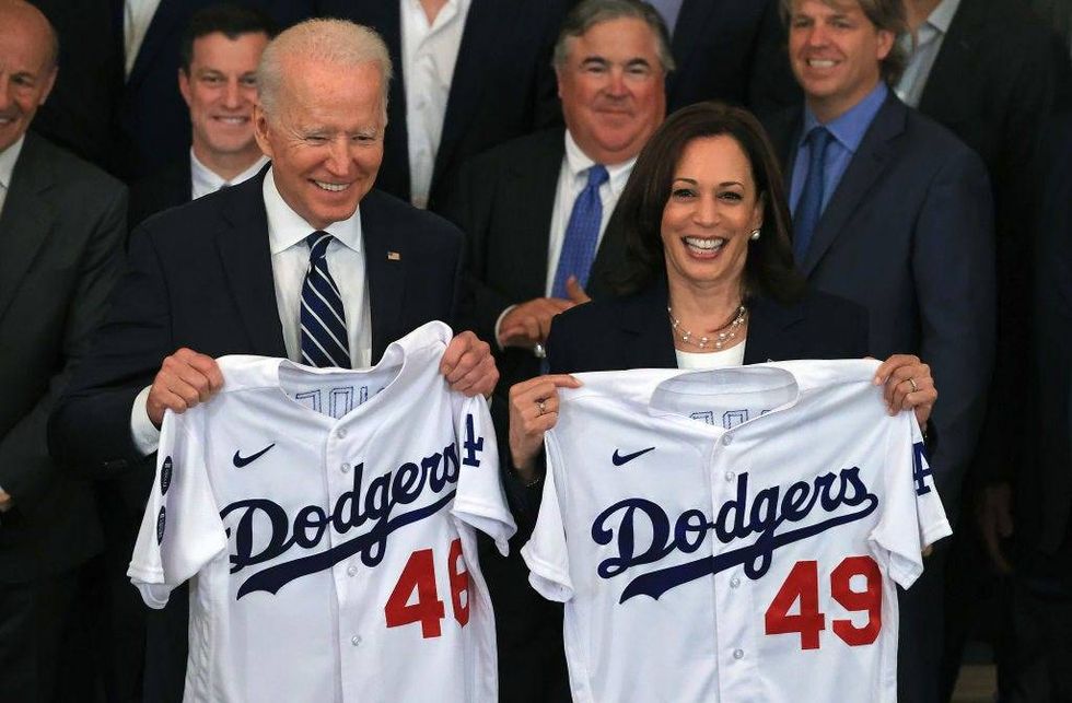 U.S. President Joe Biden and Vice President Kamala Harris pose with the jerseys given to them by the 2020 World Series champion Los Angeles Dodgers during a congratulatory event in the East Room of the White House on July 02, 2021 in Washington, DC.