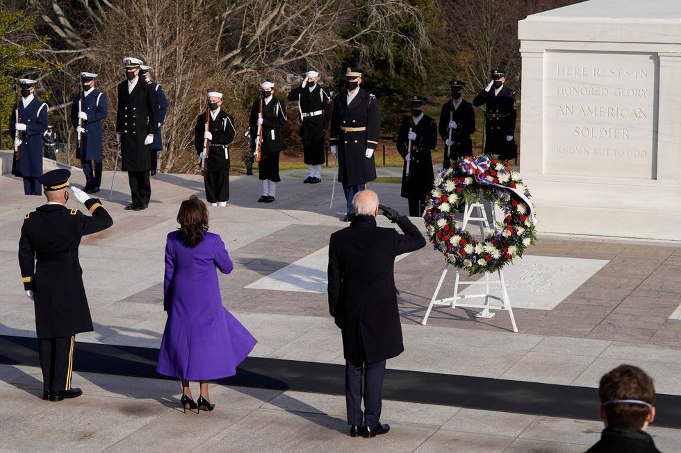 U.S. President Joe Biden (C), Vice President Kamala Harris, and Major General Omar J. Jones salute at the Tomb of the Unknown Soldier at the Arlington National Cemetery on January 20, 2021 in Arlington, Virginia. During today