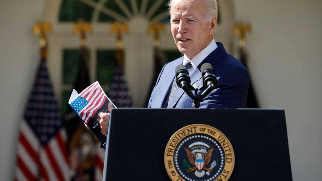 U.S. President Joe Biden holds up a piece of paper he says highlights a plan by Sen. Rick Scott (R-FL) while delivering remarks about lowering health care costs in the Rose Garden at the White House on September 27, 2022 in Washington, DC.