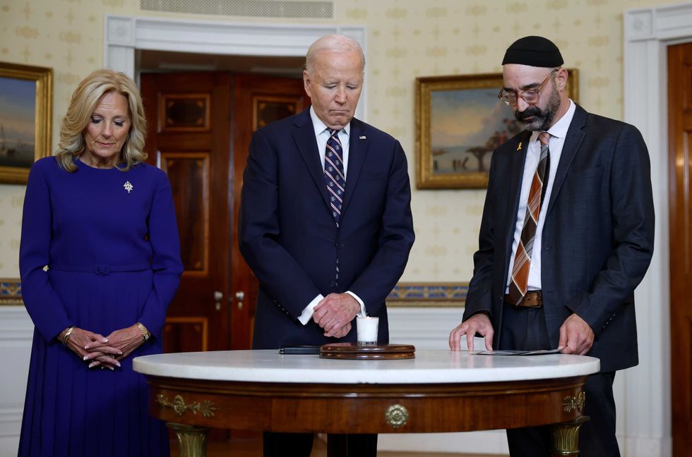 U.S. President Joe Biden participates in a moment of silence at a remembrance ceremony on the one-year anniversary of the Hamas attack on Israel in the Blue Room at the White House on October 7, 2024 in Washington