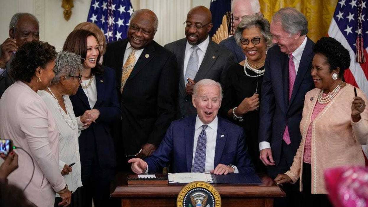 U.S. President Joe Biden signs the Juneteenth National Independence Day Act into law in the East Room of the White House on June 17, 2021 in Washington, DC. The Juneteenth holiday marks the end of slavery in the United States and the Juneteenth National Independence Day will become the 12th legal federal holiday — the first new one since Martin Luther King Jr. Day was signed into law in 1983. (Photo by Drew Angerer/Getty Images)