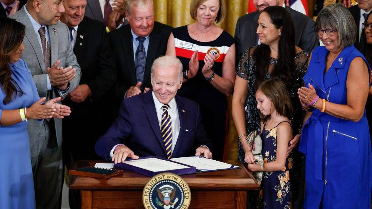 U.S. President Joe Biden smiles after signing The PACT Act in the East Room of the White House August 10, 2022 in Washington, D.C.