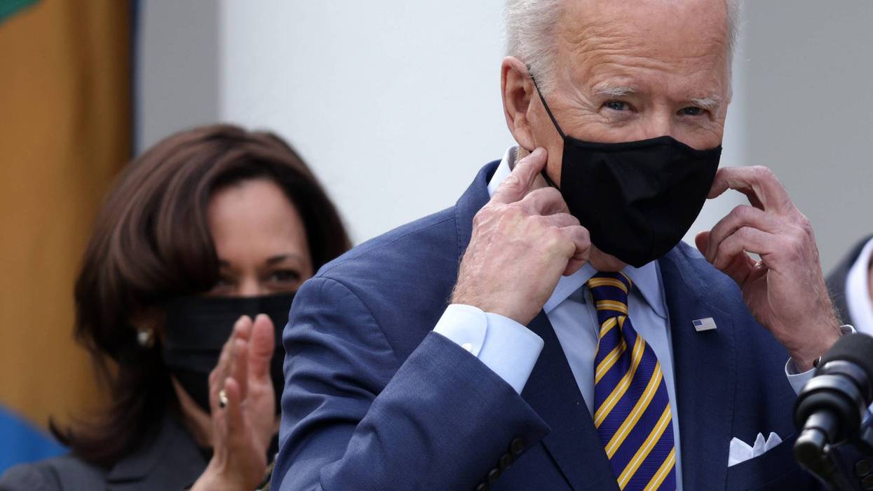 U.S. President Joe Biden speaks as Vice President Kamala Harris looks on during an event in the State Dining Room of the White House