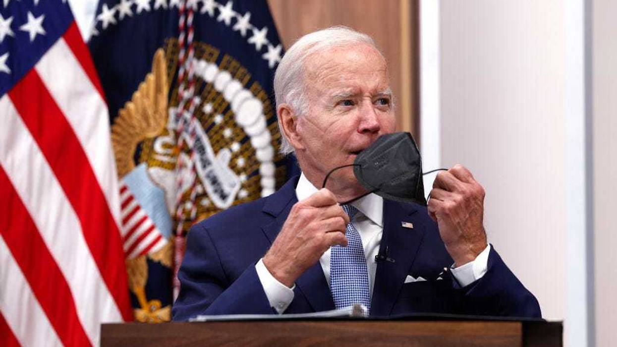 U.S. President Joe Biden takes his face mask off during a meeting on the U.S. Economy with CEOs and members of his Cabinet in the South Court Auditorium of the White House on July 28, 2022 in Washington, DC.